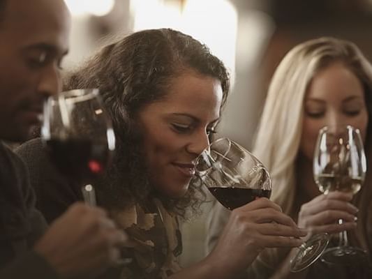 A group of friends tasting red wine at Originals Hotels