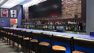 Modern, well-stocked Racebook Bar at Hilton Santa Fe Buffalo Thunder, featuring an array of liquor bottles