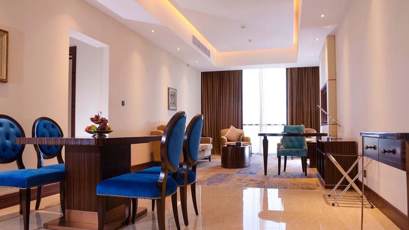 Living & dining area with tiled floors in Ambassador Suite at Warwick Al Khobar