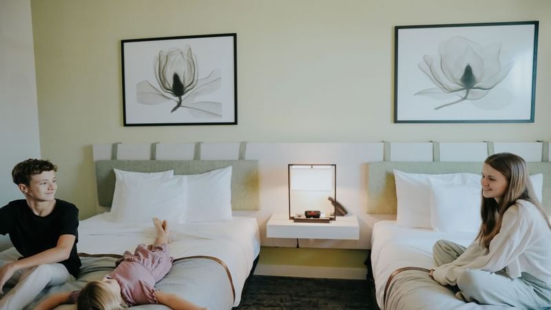 Kids sitting on beds at The Lodge 30A