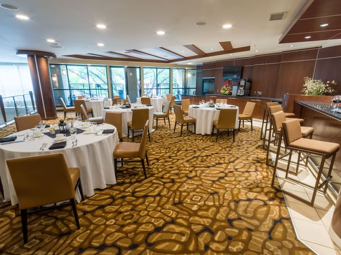 Banquet tables with bar-height chairs in an event room at Metterra Hotel on Whyte