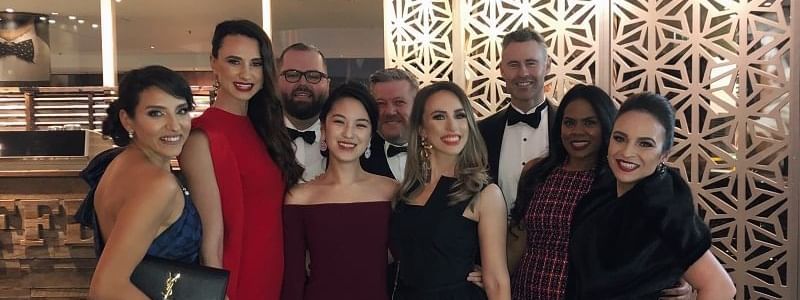 Elegantly dressed group posing together at a special event in Novotel Sydney International Airport