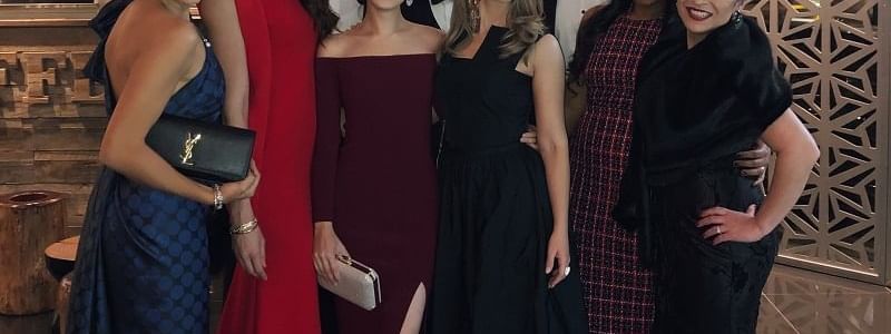 Elegantly dressed group posing together at a special event in Novotel Sydney International Airport