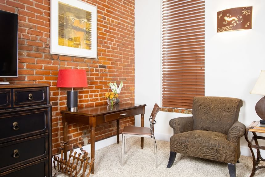 Work desk, comfy chair & TV in King Superior Southwest at Retro Suites Hotel