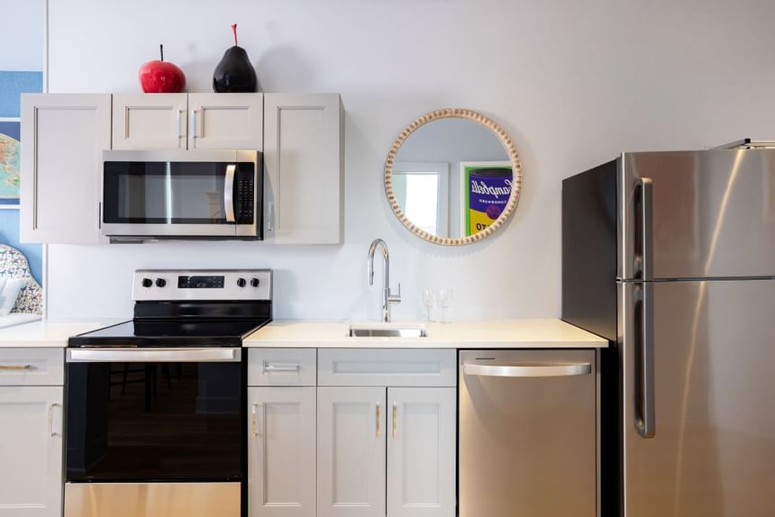 Kitchen area with pantry, mirror & refrigerator in King Premiere at Retro Suites Hotel