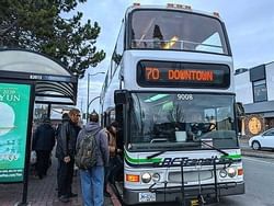 a group of people boarding a public bus