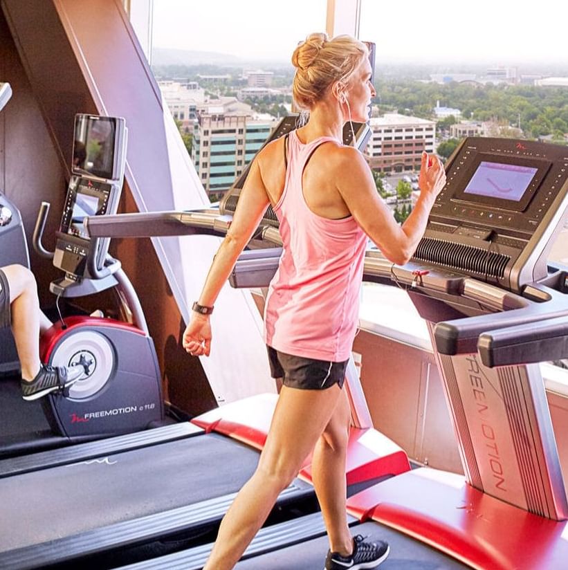 woman working out on a treadmill at the Grove Fitness Club and Spa