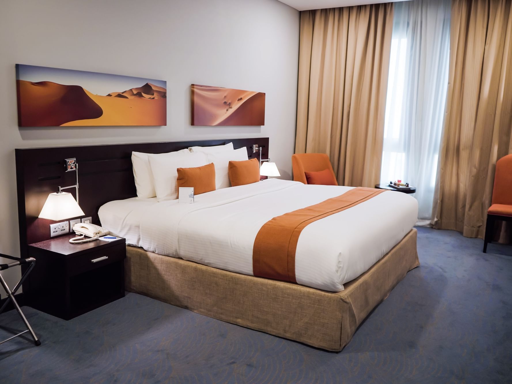 Cozy bed & nightstand in Superior Room at City Seasons Hotels