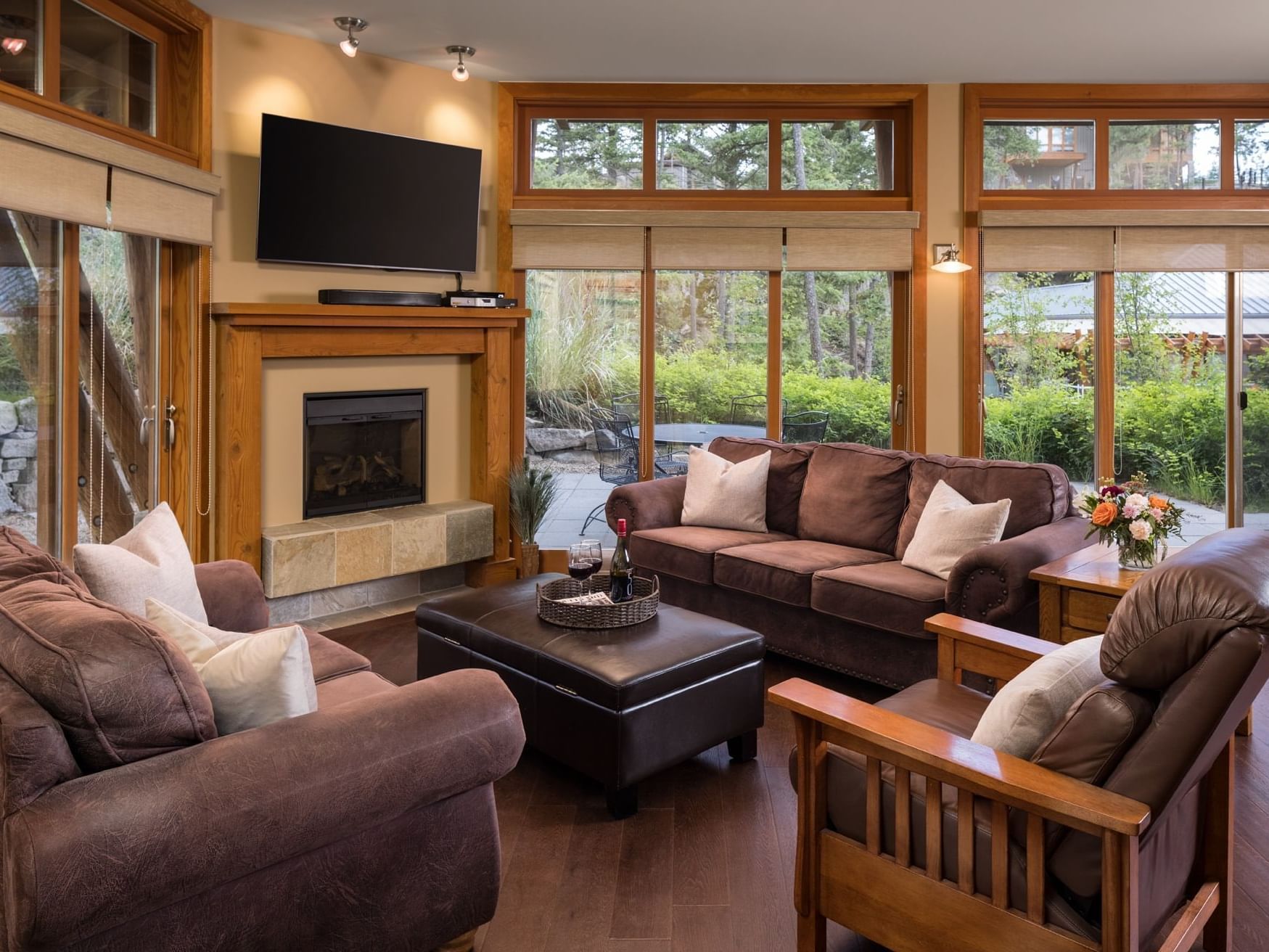 Spacious living room with large sofas, fireplace, and TV at Outback Lakeside Vacation Homes in Vernon.