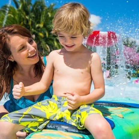 A mother and son play at a splash pad in Aquatica, soon to be home to Turi's Kid Cove.