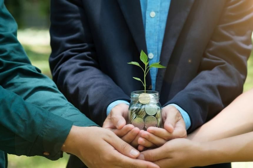 Carbon Neutral Britain featuring hands holding a seedling tree