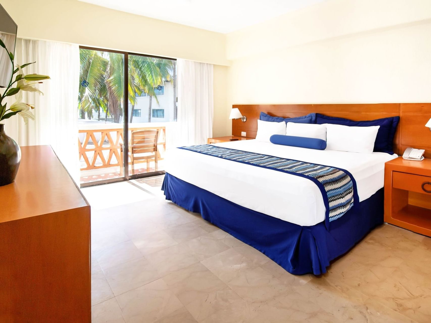 Nightstand by the bed in 2 Bedroom Family Suite at Plaza Pelicanos Grand Beach Resort