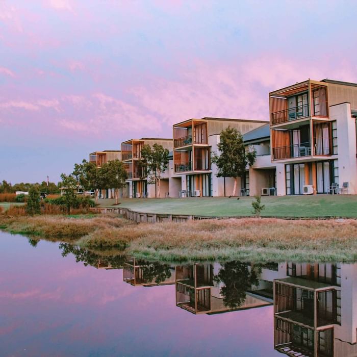 Mercure Kooindah Waters at twilight with reflections in calm lake water