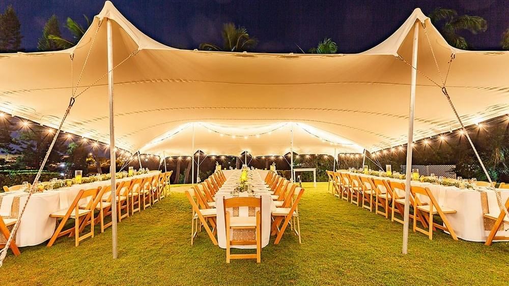 Lakeside Lawn evening event dining area setup under a tent surrounded by greenery at Mercure Hotel Townsville