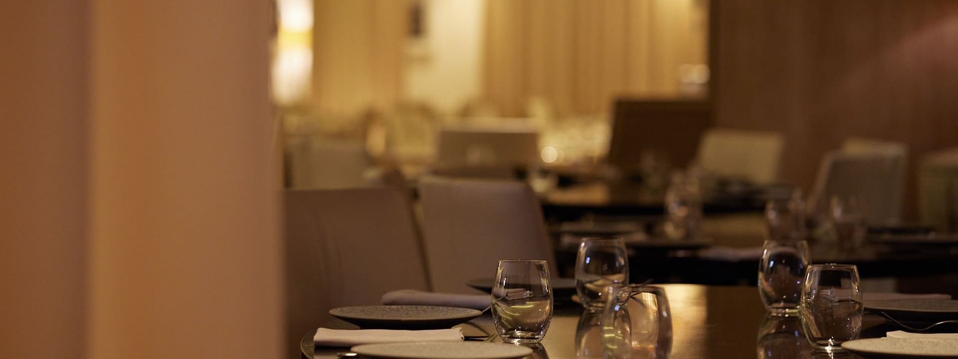 Dining table set with plates, silverware & glasses in Modo Mio restaurant at Crown Promenade Perth