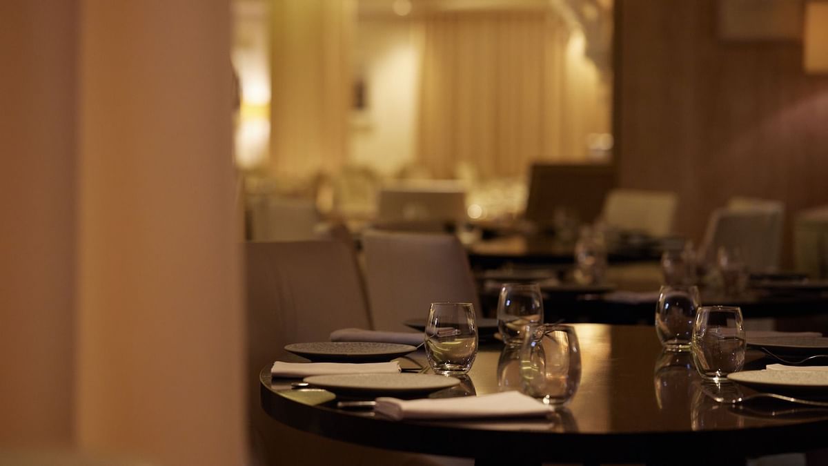 Dining table set with plates, silverware & glasses in Modo Mio restaurant at Crown Promenade Perth