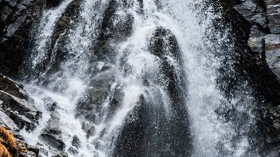 A stunning view of a waterfall near Falkensteiner Hotels