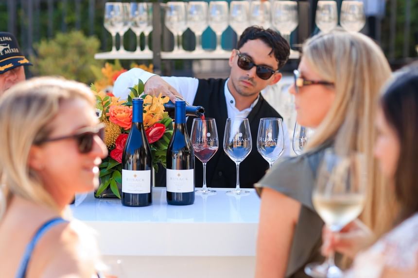 Bartender pouring wine at the Catalina Wine Mixer of Catalina Island luxury hotels