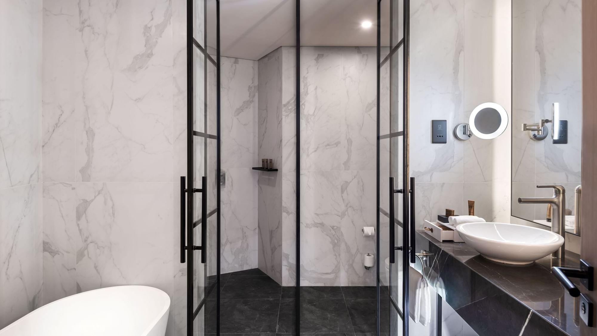 Spacious and elegant bathroom with a freestanding tub and a walk-in shower at Paramount Hotel Midtown