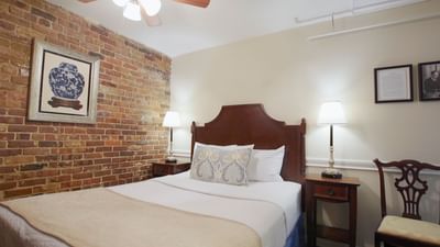 Bed & chair in Cozy One Queen Bed Room at Hotel St. Pierre