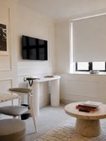 Modern One Bedroom Apartment living area with contemporary furniture and natural light at The Capital Hotel, Apartments & Townhouse.