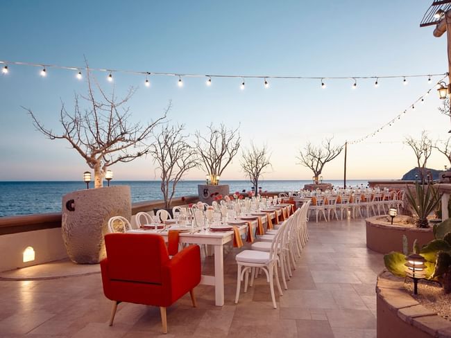 Cortez Grill and Restaurant set for a reception with long tables and a stunning ocean view at Hacienda del Mar Los Cabos