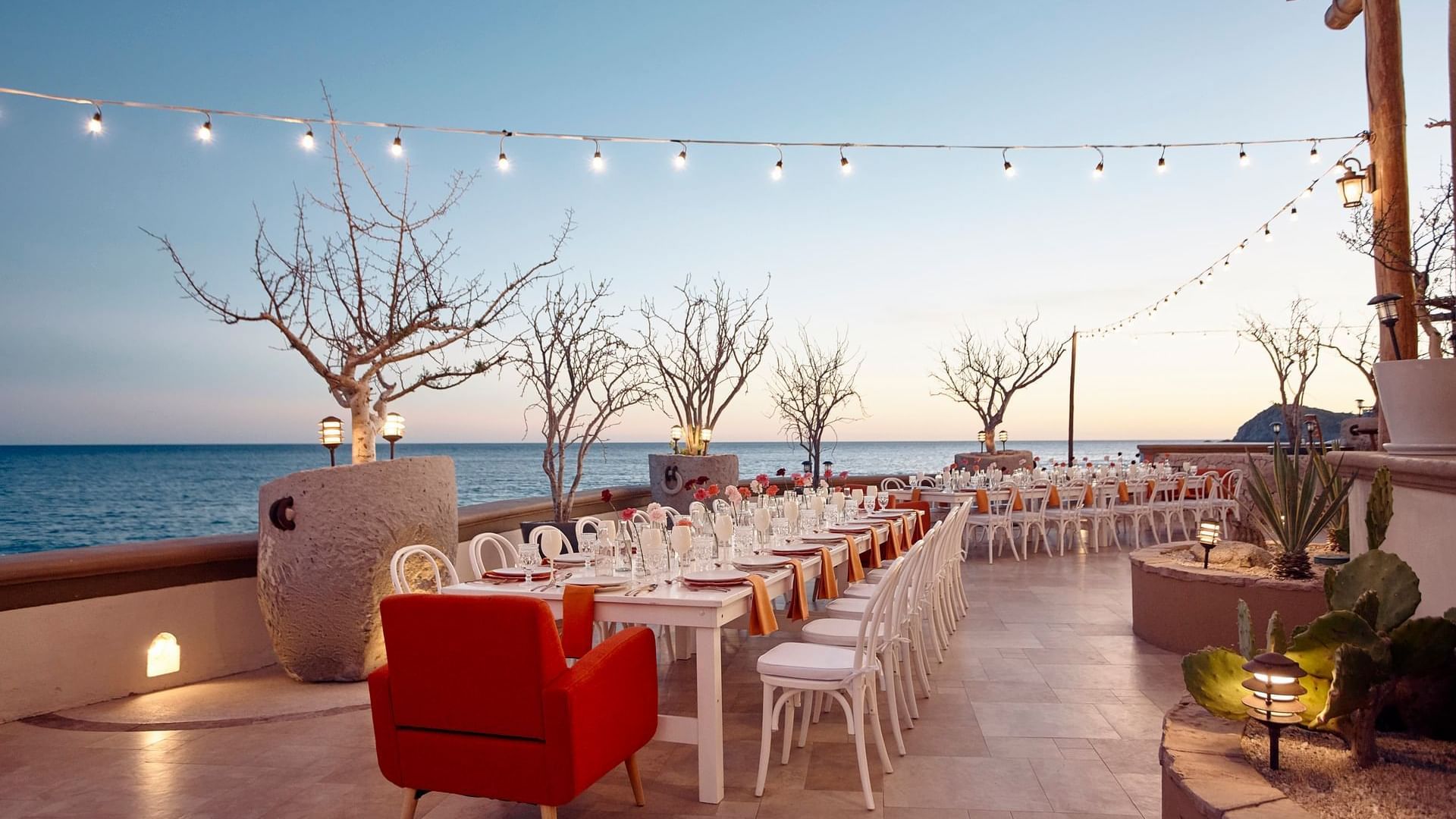Cortez Grill and Restaurant set for a reception with long tables and a stunning ocean view at Hacienda del Mar Los Cabos