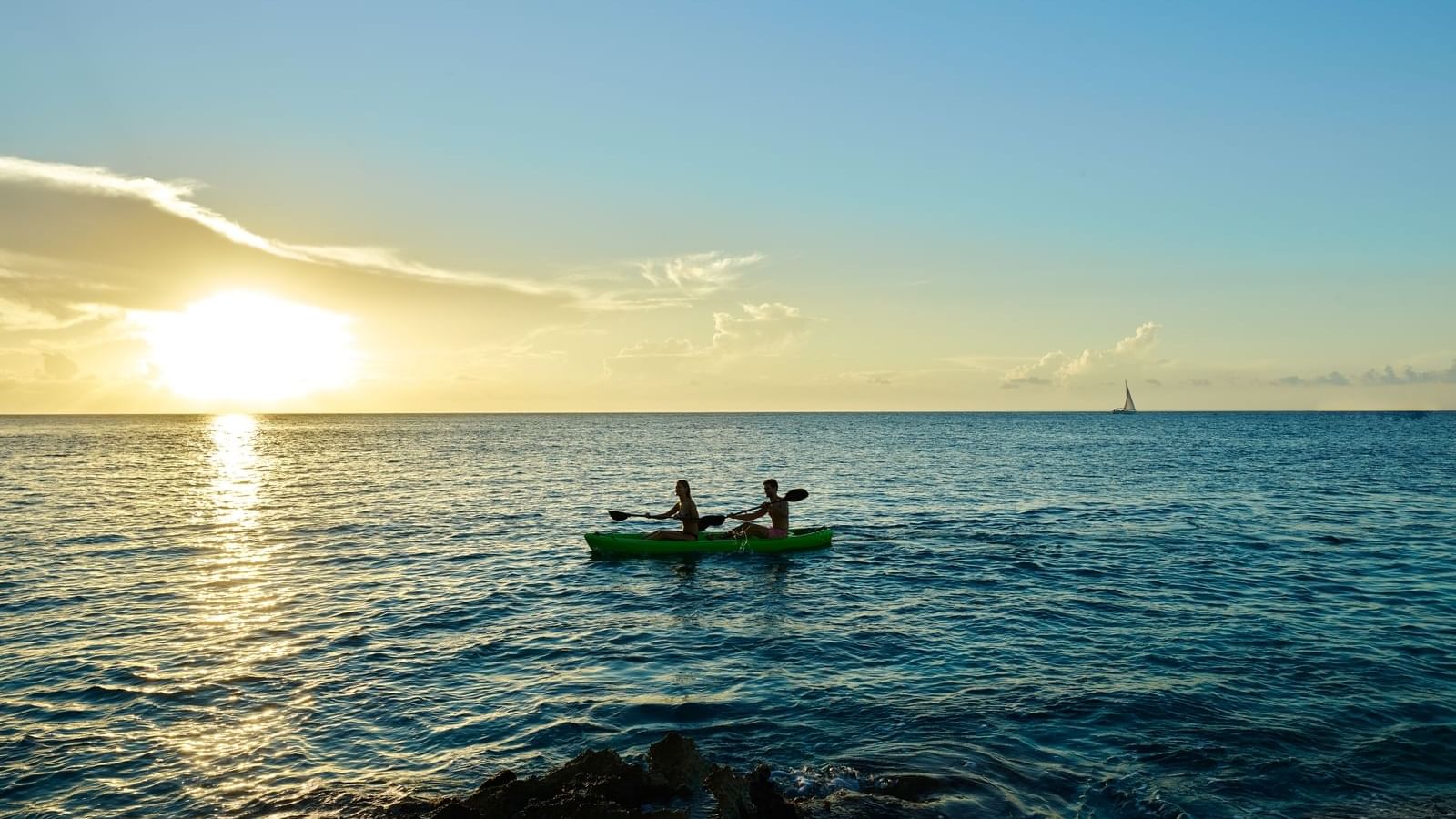 Two people rowing on the ocean near FA Cozumel All Inclusive