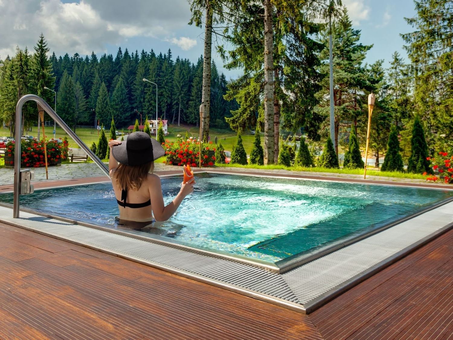 Lady in the outdoor hot tub area at Ana Hotels Sport