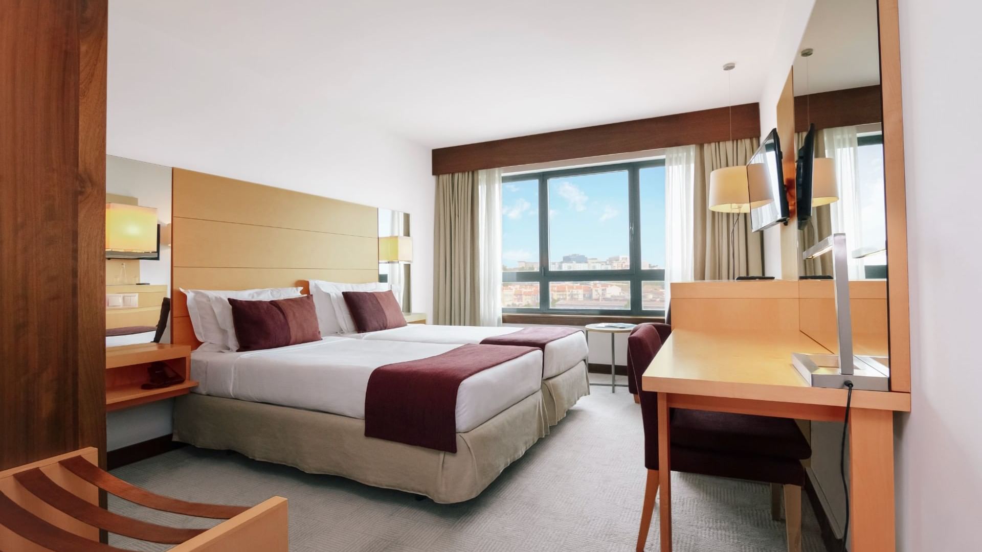Twin beds & work desk in Standard Room at Bensaude Hotels