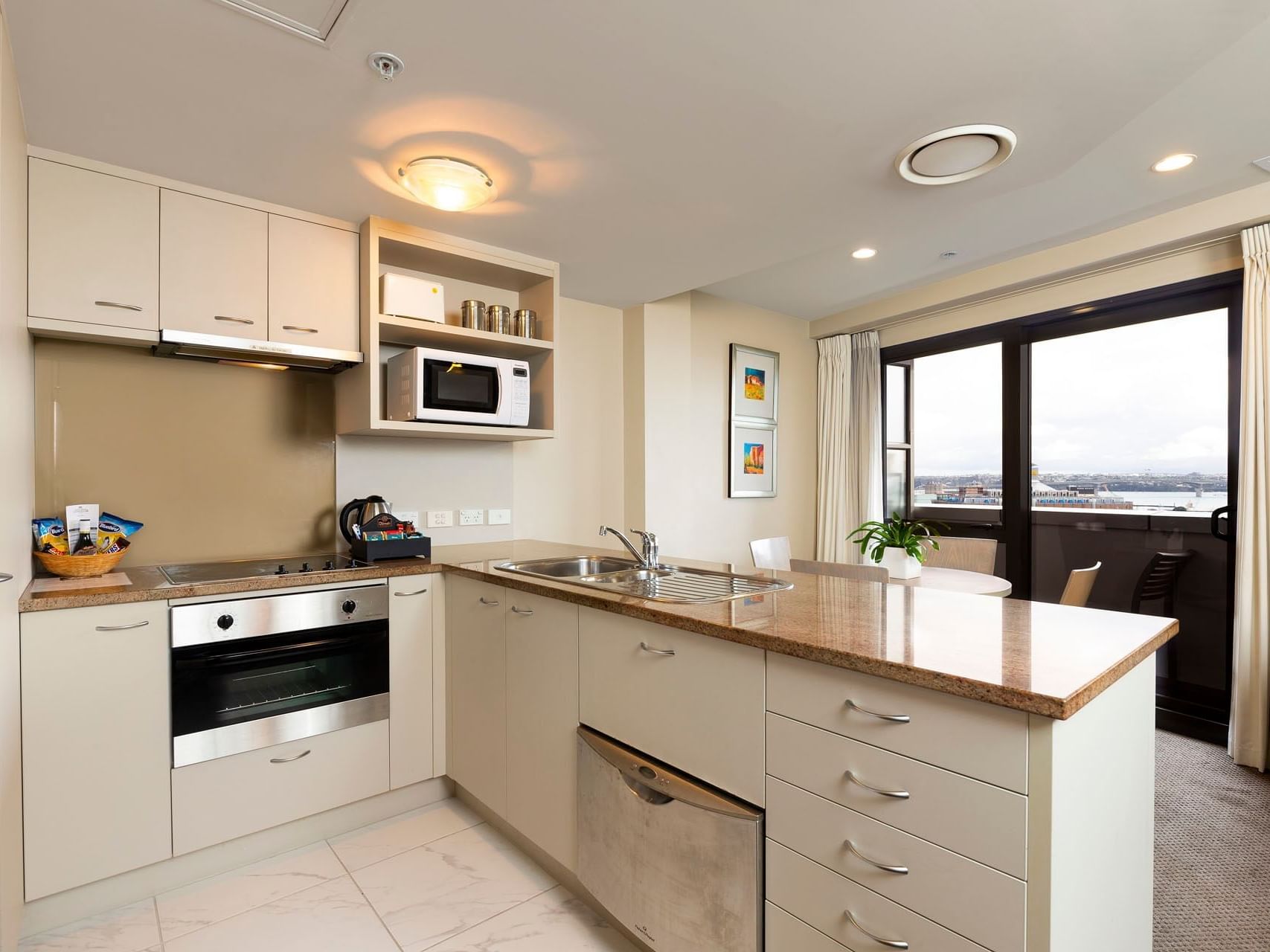 Kitchen with appliances in Harbour View at Hotel Grand Chancellor