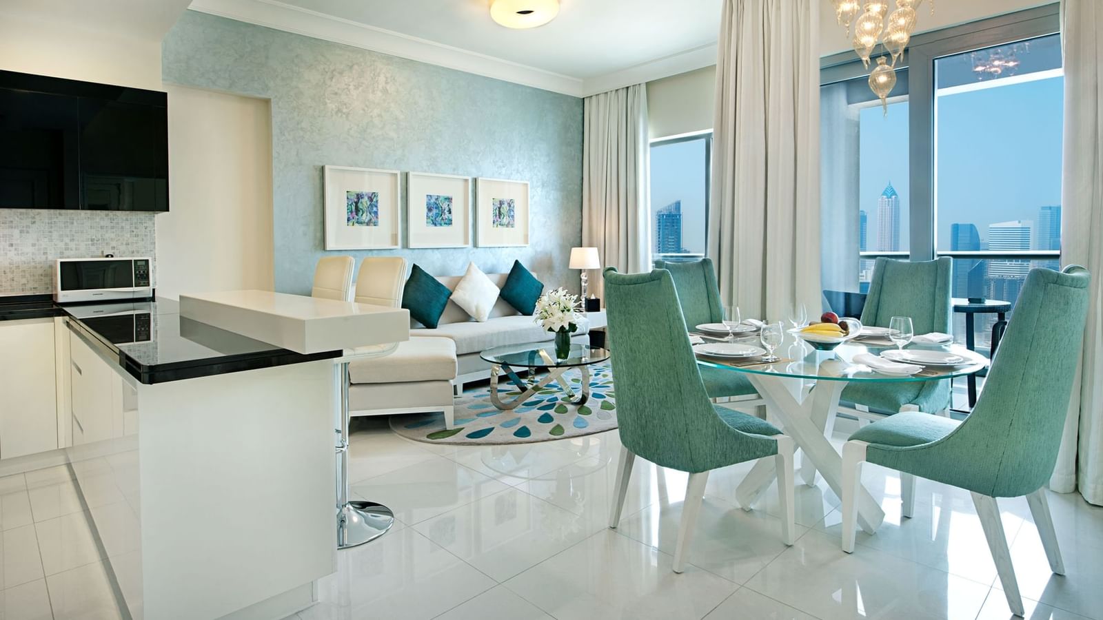 Living and dining area with city view in Deluxe Room, one of the hotel rooms in Dubai at DAMAC Maison Mall Street