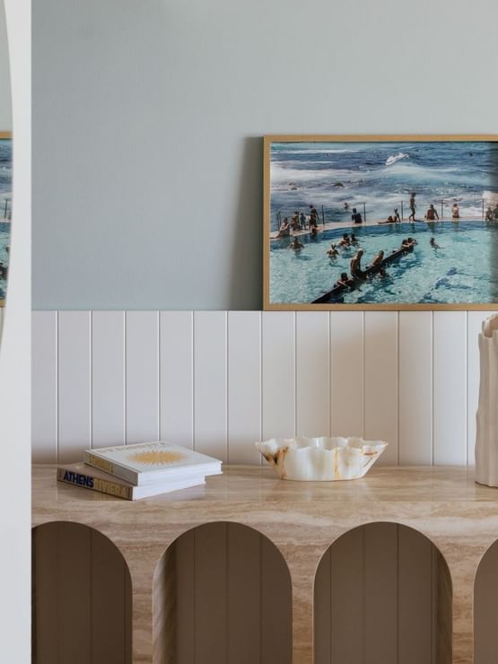 Coastal Two Bedroom Suite at Elysium Manly by books on a stone console, a top choice for Manly accommodation