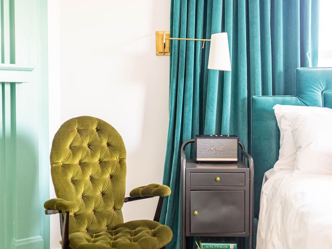 blue curtains next to bed with blue headboard