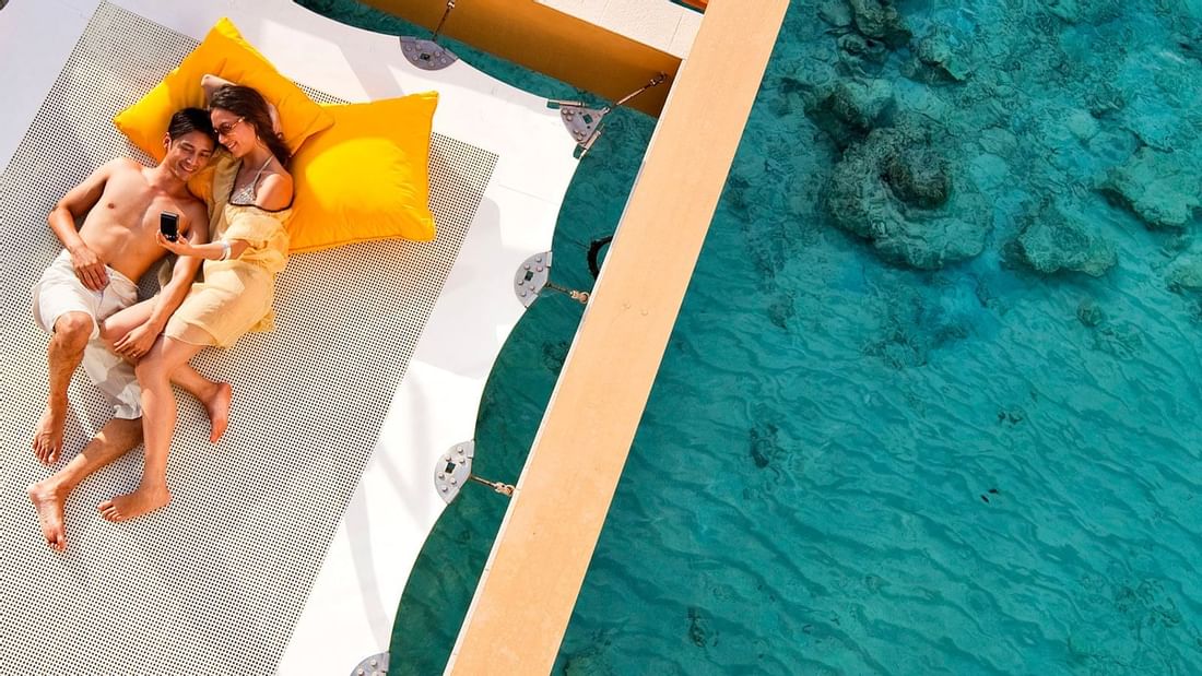 Couple on a hammock near Pullman Cairns