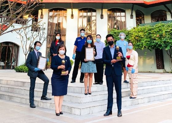 Hotel staff holding awards at Chatrium Royal Lake Yangon