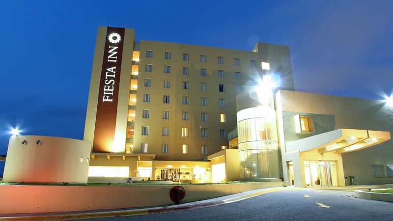 Junior Queen Room with a Queen-sized bed, couch, TV and a work desk at Fiesta Inn Suites Aeropuerto del Bajio