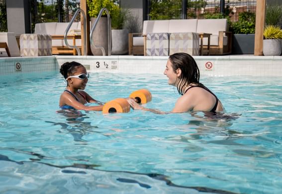 Mom and little daughter enjoying in pool at The Rockaway Hotel