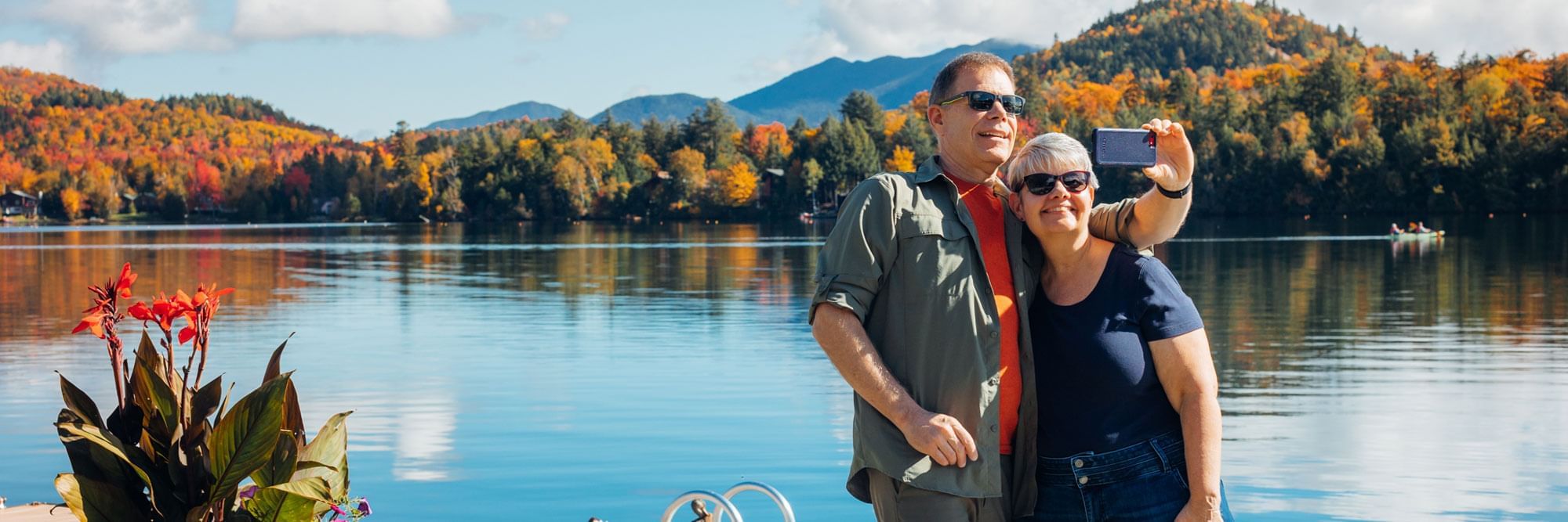 Couple taking an autumn selfie next to Mirror Lake.