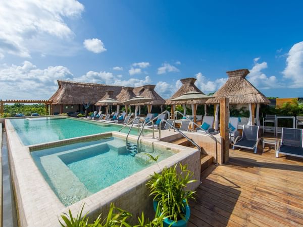 Sunbeds by the outdoor pool in Naay Tulum, La Colección