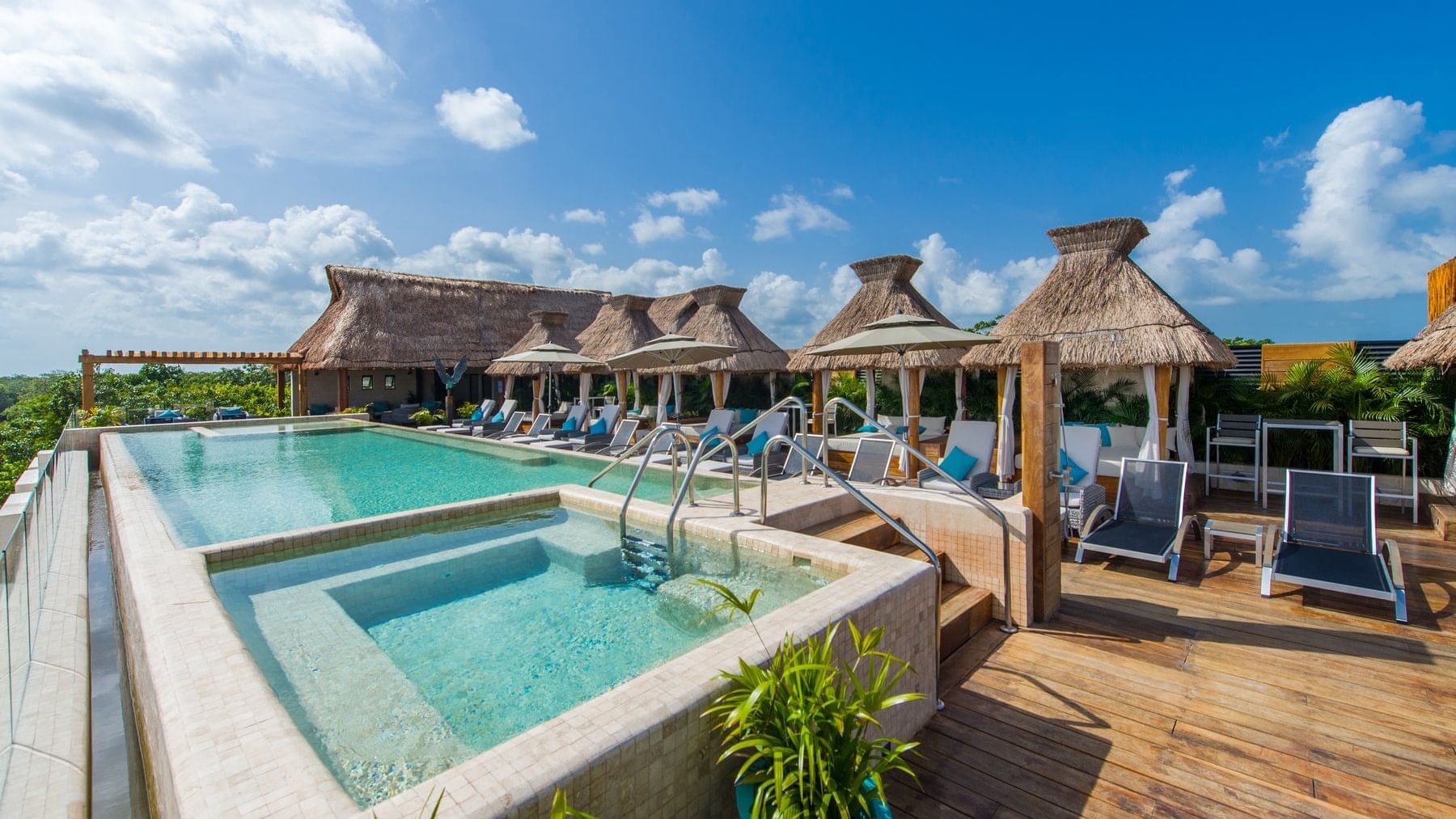 Outdoor pool with cabanas at  Naay Tulum Curamoria Collection