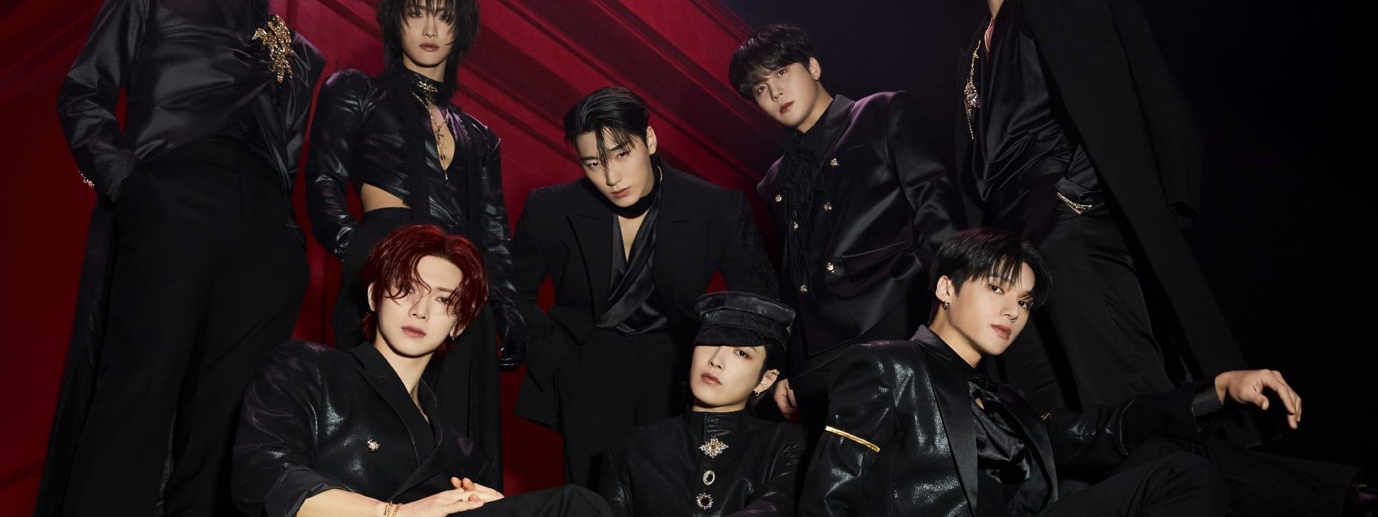ATEEZ band members dressed in black posing for a photo at the In Your Fantasy World Tour 2026.