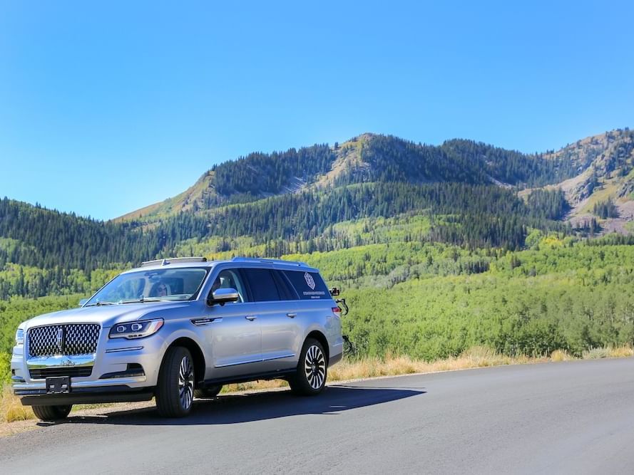 Lincoln Navigator parked with a mountain in the background near Stein Eriksen Residences