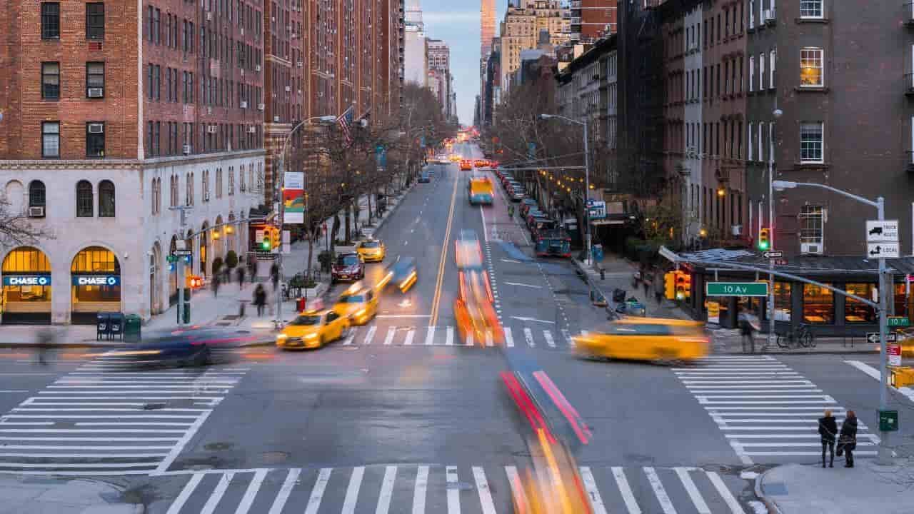 a city street with tall buildings and moving cars