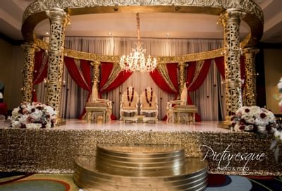 indian wedding gold altar with red curtain draping