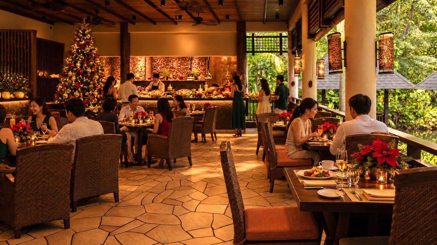Guests enjoying Christmas Day brunch in the Pomelo restaurant adorned with a decorated tree and festive poinsettias