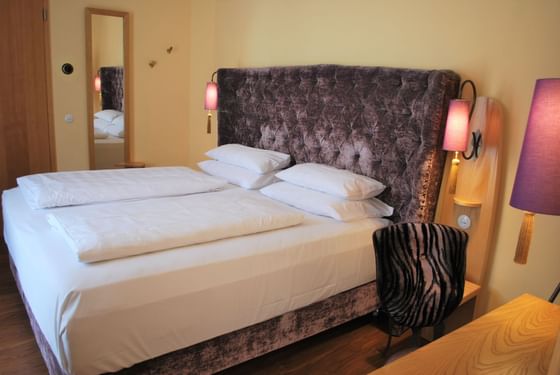 Large bed in Grand Deluxe Double Room at Classic Hotel Harmonie