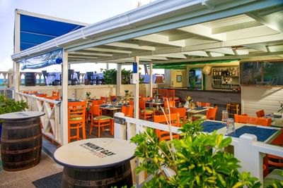 Dining area with bar shelves in Sea Grape Bar & Restaurant at Dover Beach Hotel