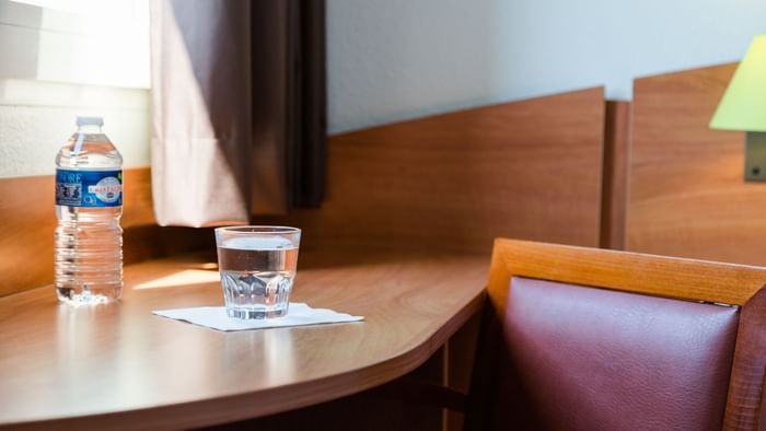 Close up on a glass of water kept on a table at Hotel Agora