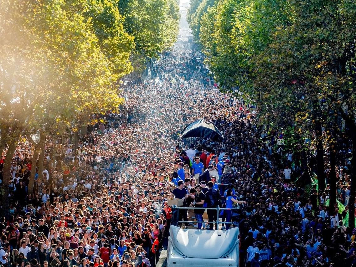 People on truck amidst crowd in Techno Parade, Originals Hotels